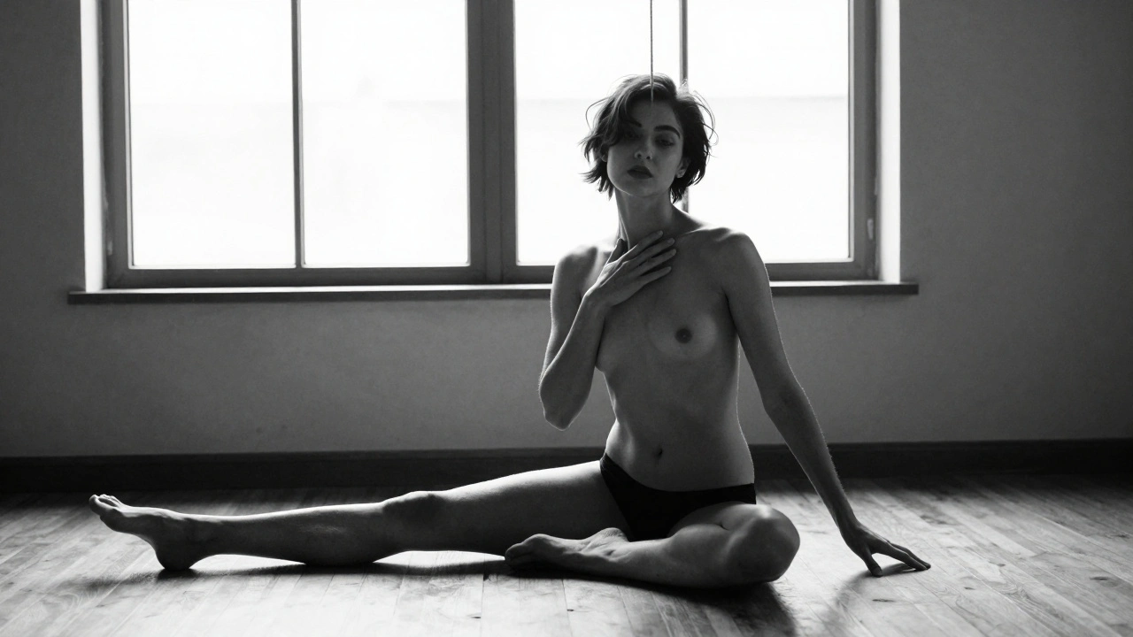 Model seated quietly, hand touching collarbone, natural light, introspective mood.